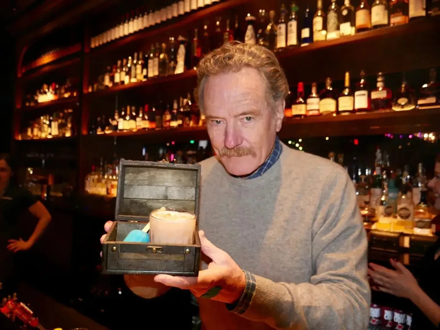 Bryan Cranston showcasing a drink at Puttshack