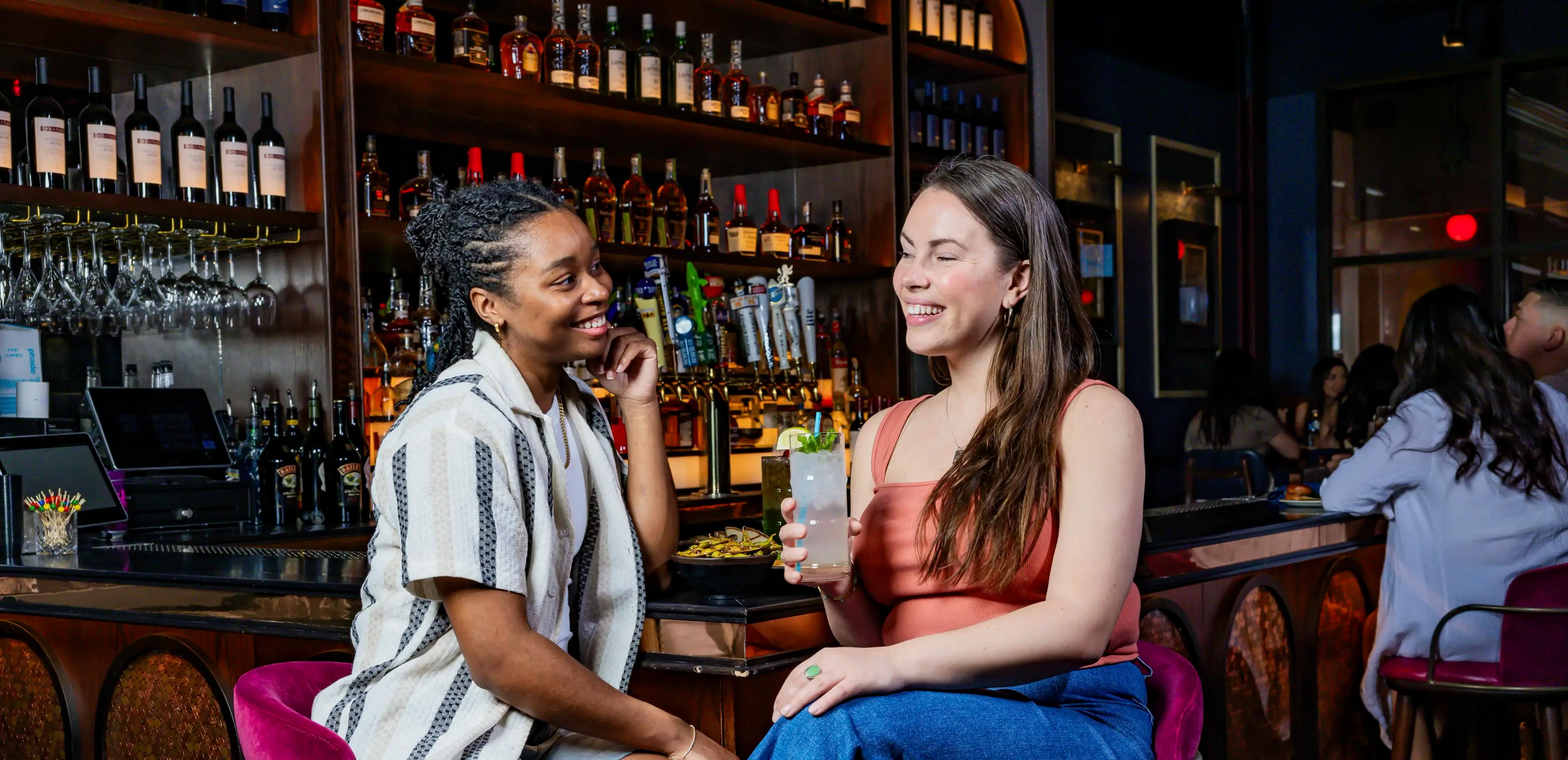 Two women having drinks at Puttshack