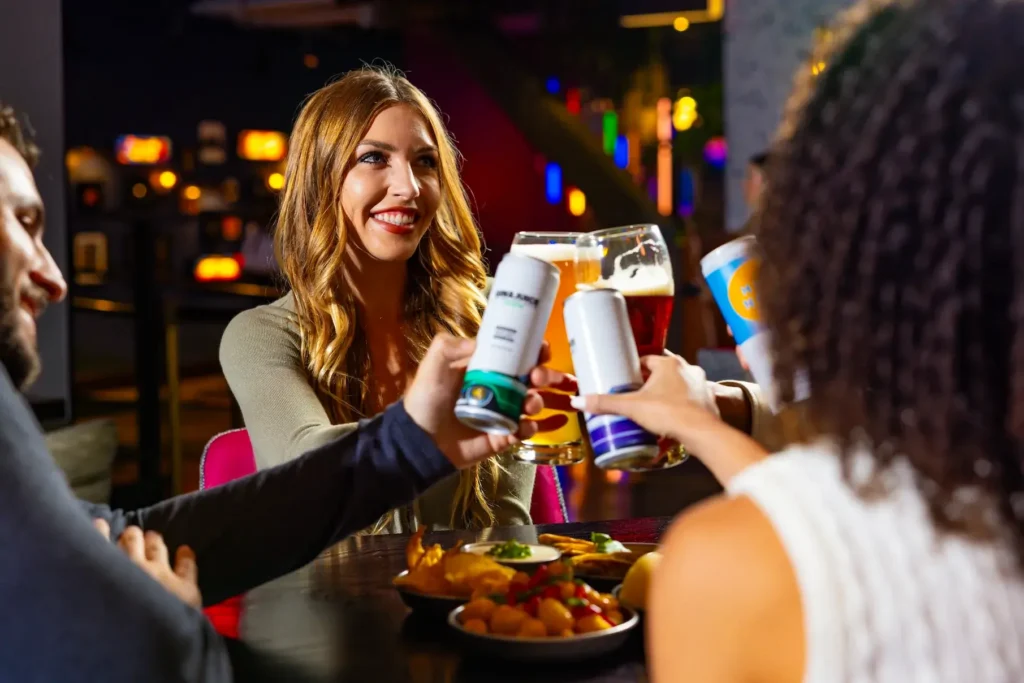 Adults raising their glasses at Puttshack