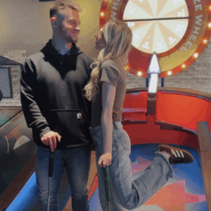 a couple enjoying mini golf