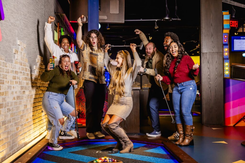 a group of friends celebrating at Puttshack